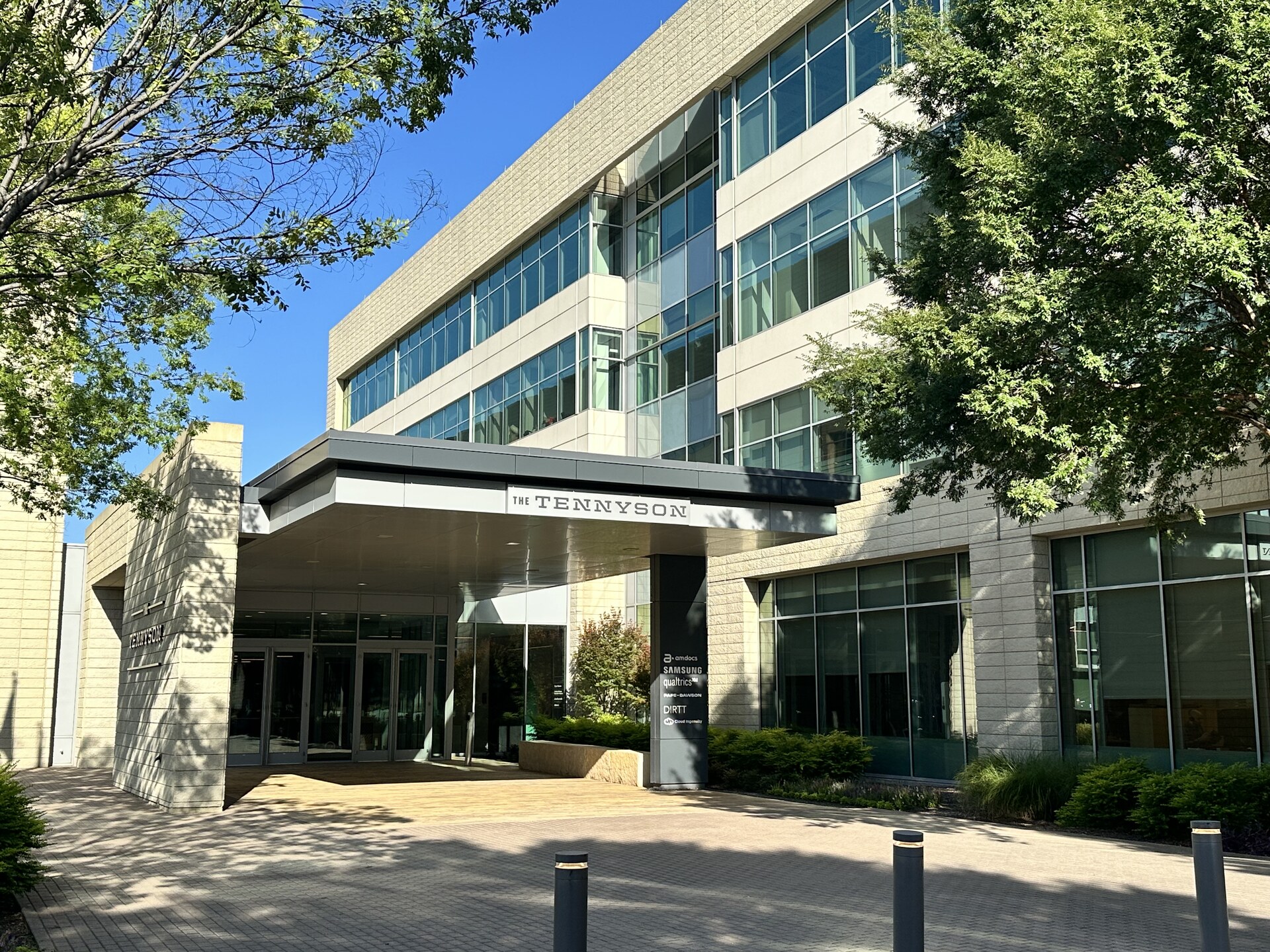 The Tennyson — building entry lobby with natural stone and floor-to-ceiling glass
